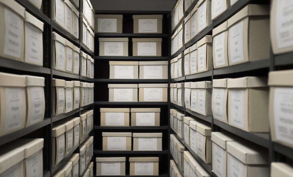 Indoor storage details in a manufacturing enterprise, black shelves with white office boxes